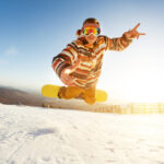 Snowboarder,Is,Having,Fun,Jumps,And,Drop,At,Ski,Slope